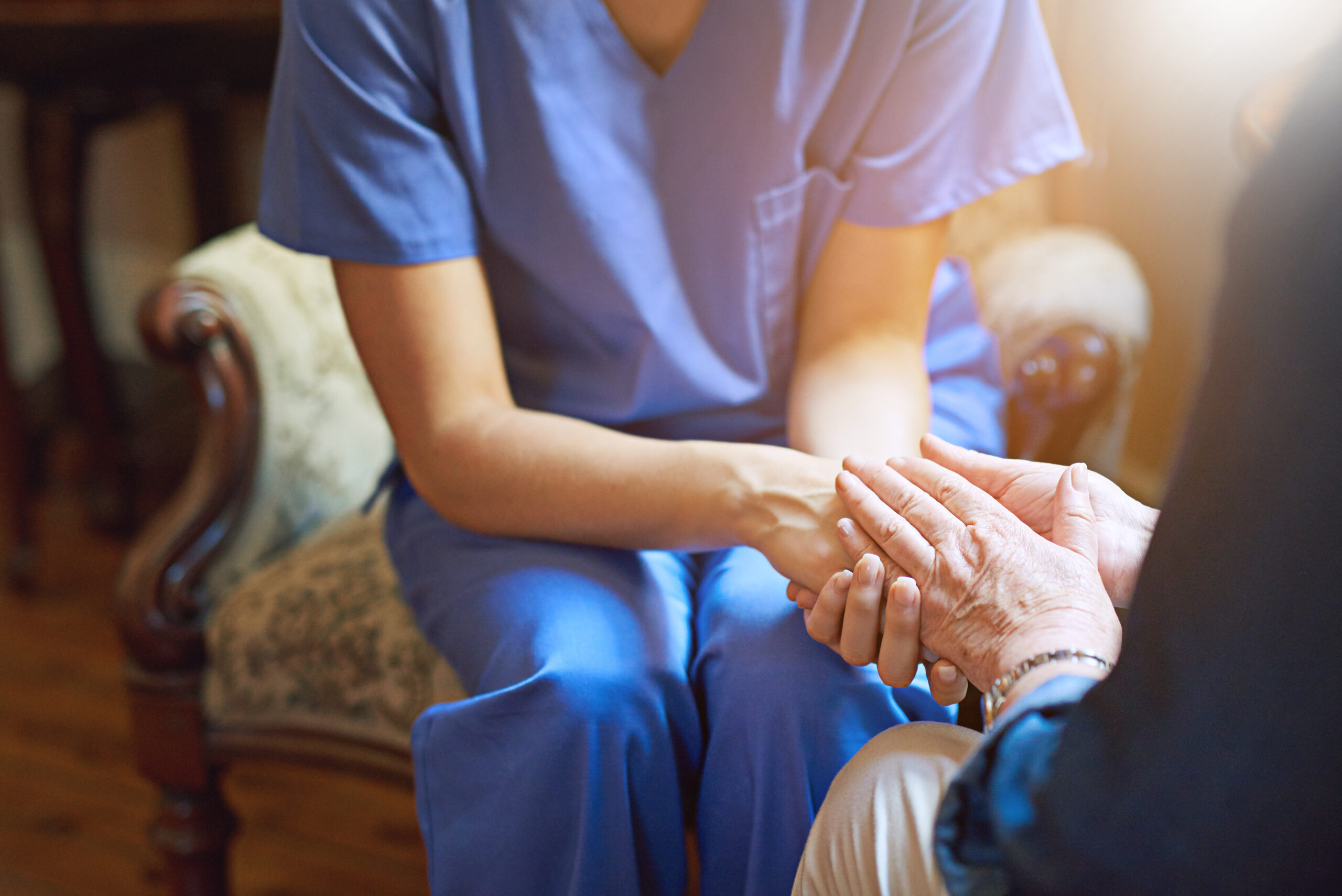 Committed to comfort and care. Shot of a resident being consoled by a nurse in a retirement home. Nursing Home Medicaid Qualification
